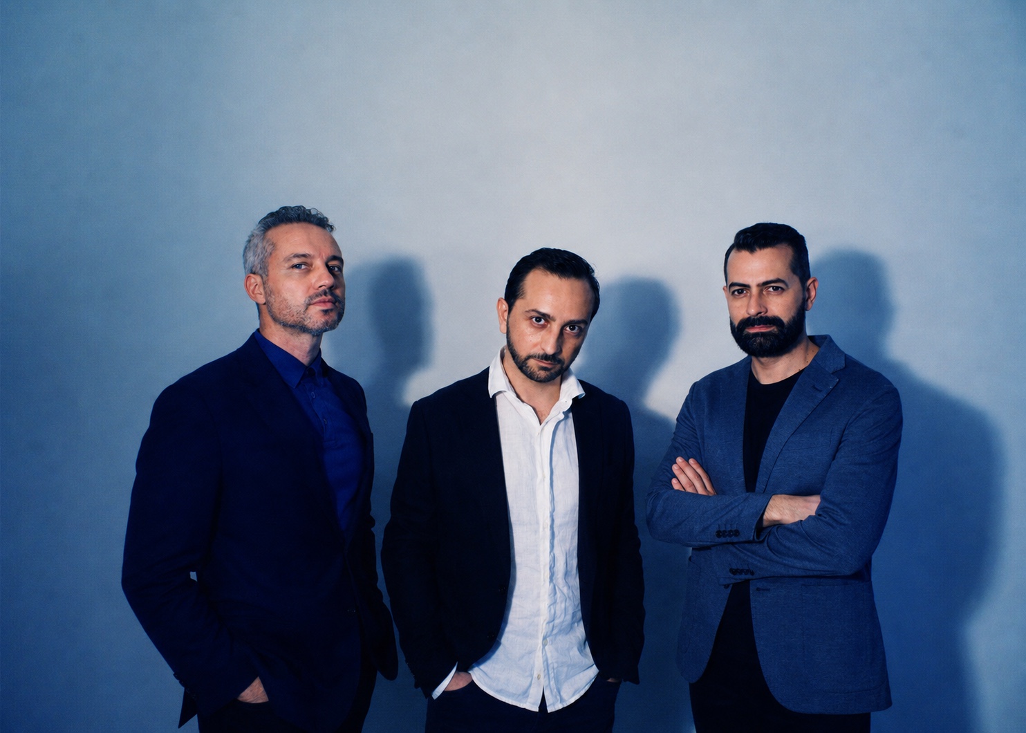 Posh together against a blue studio backdrop